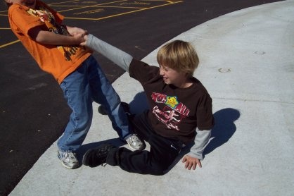 One kid helping another kid up off the ground; teamwork. | $assy ...