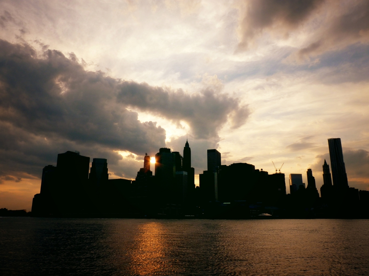 The New York City skyline in silhouette at sunset.... | NY Through ...