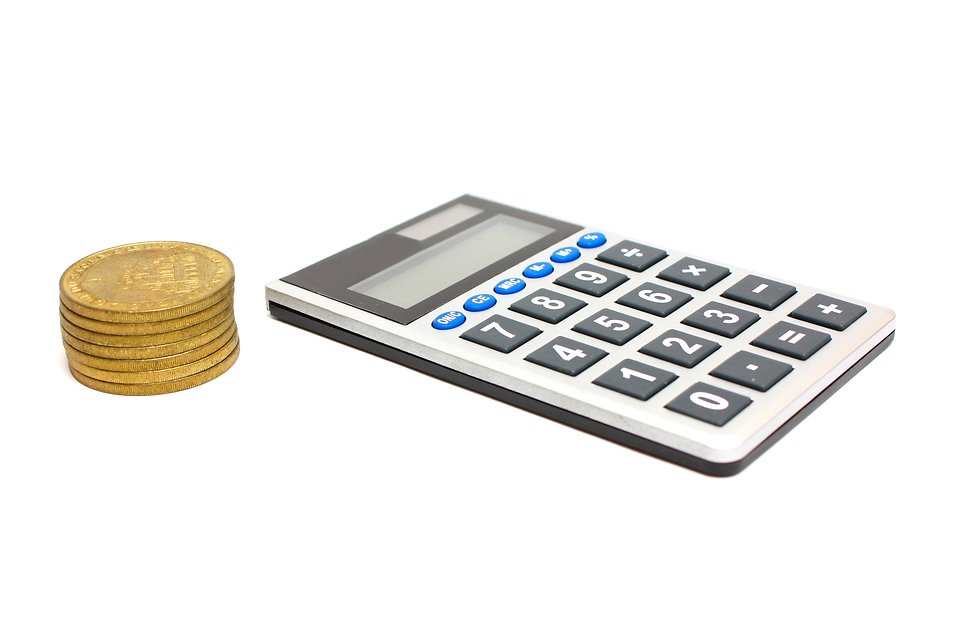 Free Stock Photos | A calculator and a stack of gold coins ...