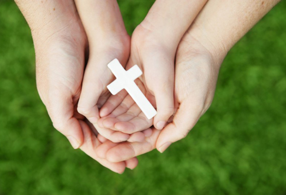 hands holding a cross : Catholic Chaplaincy