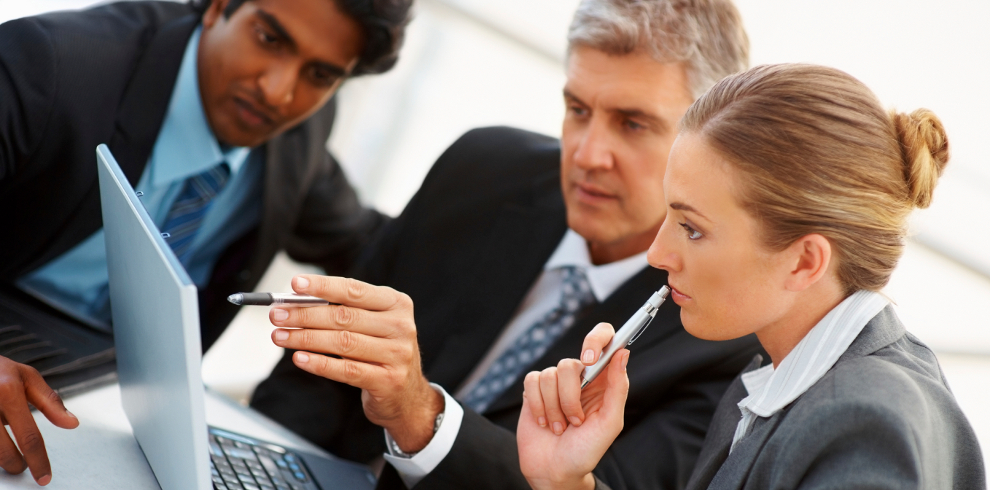 Team of business people working together on a laptop | The Powerhouse