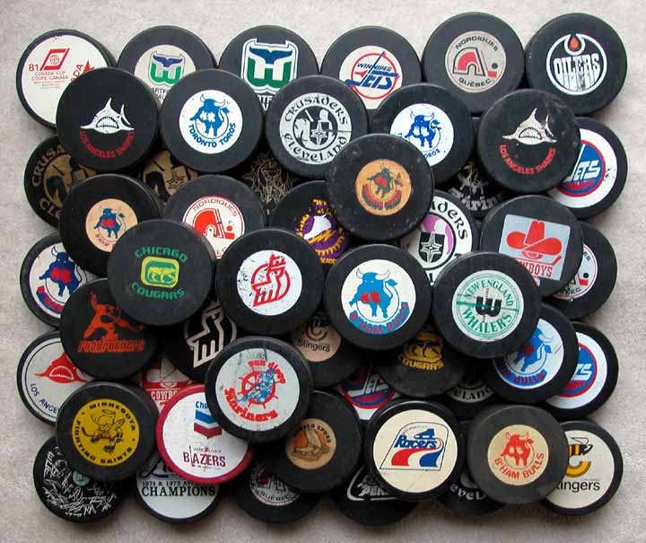 Mostly WHA Hockey Puck Group of 56: GAMEWORNAUCTIONS.NET