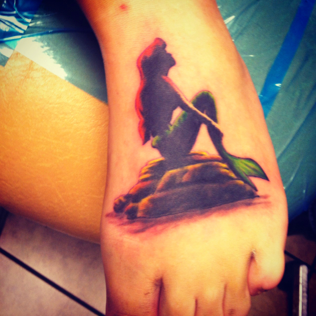 The Little Mermaid silhouette tattoo.... Not sure on the color ...
